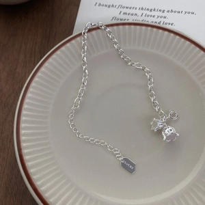 S925 sterling silver lily of the valley bracelet with lucky tag on ceramic plate