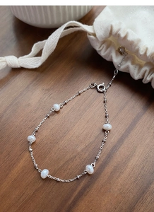 Close-up of S925 sterling silver bracelet with five lustrous white freshwater pearls