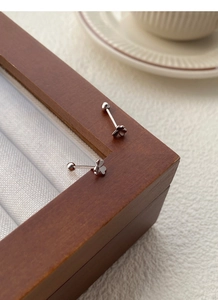 Close-up of S925 sterling silver clover stud earrings with secure screw ball back closure