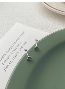 Macro detail of S999 silver clover stud earrings with a secure screw-back design