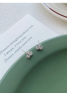 Macro shot of S925 sterling silver clover stud earrings with sparkling zircon stones