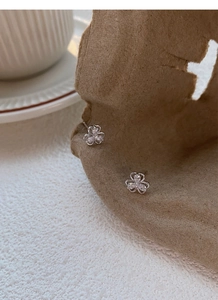 Detail of clover earrings featuring pear-cut cubic zirconia in a silver finish