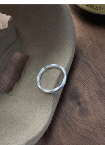 Detail of Mobius silver ring featuring a matte brushed finish and adjustable open design
