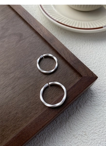 Macro view of matte S999 silver Mobius rings showing delicate frosted texture and open band
