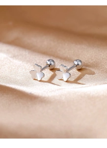 Detailed macro of polished S999 silver clover stud earrings with secure screw back closure