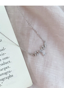 Close-up of S999 silver olive leaf necklace with sparkling zircon and teardrop pendant
