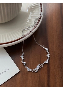 Detail of S999 silver bow bracelet with sparkling zircons and S925 hallmark stamp