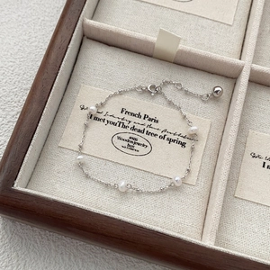 Elegant S925 sterling silver freshwater pearl bracelet on a luxury wooden jewelry box