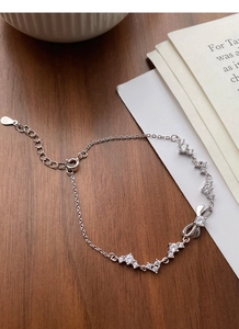 Detail of S999 sterling silver bow bracelet featuring micro-paved sparkling cubic zirconia