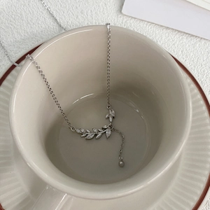 S999 sterling silver wheat ear necklace with marquise zircon stones in a ceramic cup
