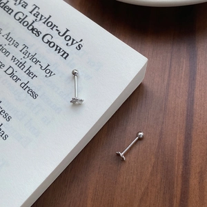 Elegant S999 sterling silver clover screw back stud earrings on a dark wooden background