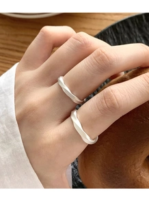 Close-up of matte silver Mobius rings worn on hand for a minimalist lifestyle look