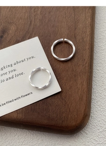 Close-up of S999 silver Mobius rings with matte brushed finish and adjustable open band