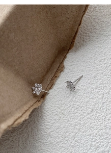 Macro shot of S999 sterling silver snowflake stud earrings with sparkling cubic zirconia