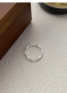 Detail of adjustable S999 silver Mobius ring with matte finish and twisted texture design