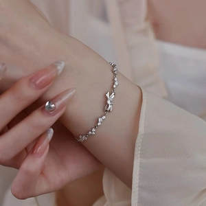 Elegant S999 sterling silver bracelet featuring a polished rabbit pendant and zircon stones