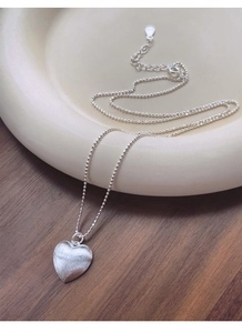Dettaglio della collana a cuore in argento S925 con finitura spazzolata e catena a sfere