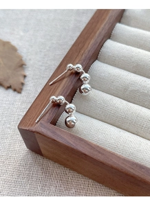 Detailed macro view of S925 sterling silver minimalist geometric bead stud earrings