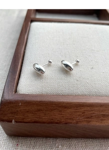 Macro detail of S925 sterling silver bean earrings with secure screw back closure