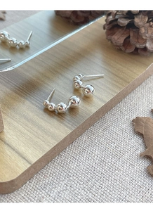 Detailed macro view of S925 sterling silver ball studs featuring a gradient bead design