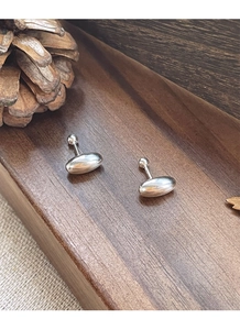 Macro shot of S925 sterling silver oval bean earrings with high polish mirror finish