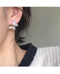 Close-up of S925 sterling silver butterfly stud earrings worn on model's ear