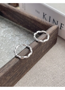 Detailed view of S925 sterling silver twisted rope rings on vintage background