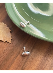 Macro detail of S925 sterling silver oval stud earrings with secure screw back closure