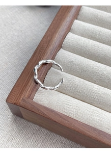 Detail of S925 sterling silver braided twist ring with adjustable open design