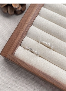 Detailed macro view of S925 sterling silver hollow heart rings on a jewelry box