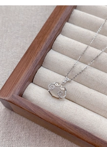 Detailed macro view of S925 sterling silver chalcedony pendant in a beige jewelry box