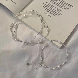 Minimalist S925 sterling silver wavy bar bracelet with freshwater pearls and silk background