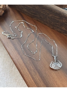 Detail of S925 silver necklace with chalcedony lock pendant and micro-set diamonds
