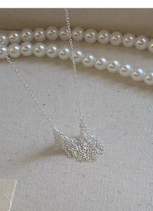 Detail of S925 sterling silver tassel pendant necklace with shimmering chain design
