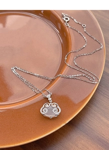 Detail of S925 silver necklace featuring a jade chalcedony ruyi lock pendant with small crystals