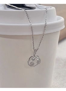 Macro detail of S925 sterling silver ruyi pendant with shimmering pavé set zircons