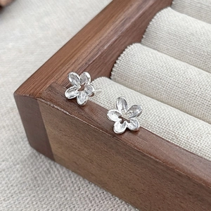 Minimalist S925 sterling silver hollow flower stud earrings with a textured matte finish