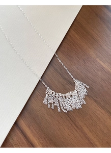 Macro shot of S925 sterling silver tassel necklace with delicate layered hanging chains