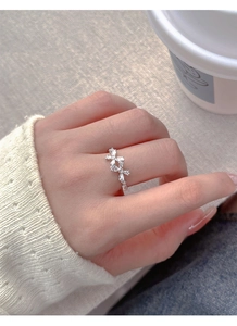 Close-up of S925 sterling silver bow ring with marquise zircon stones on finger