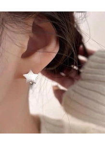 Close-up of S925 sterling silver star stud earring with a brushed matte texture finish