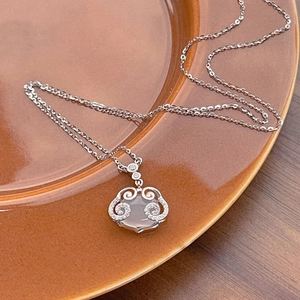 S925 sterling silver Ruyi necklace with white chalcedony pendant on ceramic plate