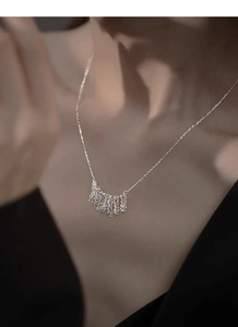 Detail of S925 sterling silver tassel fringe necklace worn on a female model
