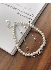 Detail of S925 sterling silver double-layer bracelet with white pearls and metal beads