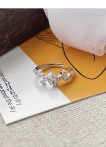 Macro detail of S925 sterling silver bow ring with sparkling cubic zirconia inlay