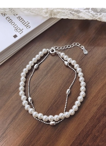 Detail of S925 sterling silver stamp on double-layer pearl and silver bead bracelet