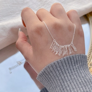 Minimalist S925 sterling silver tassel chain necklace shown on hand for elegant styling