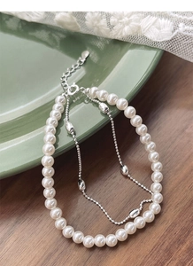 Close-up of S925 silver double-layer bracelet with pearls and olive-shaped beads