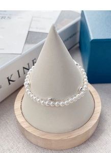 Detail view of double-layer S925 silver bracelet with pearls and olive-shaped beads