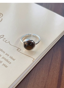 Macro shot of S925 sterling silver tiger eye ring featuring an adjustable open band design