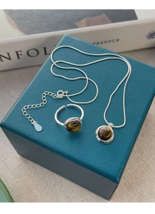 Close-up of S925 silver set featuring a tiger eye stone necklace and open ring